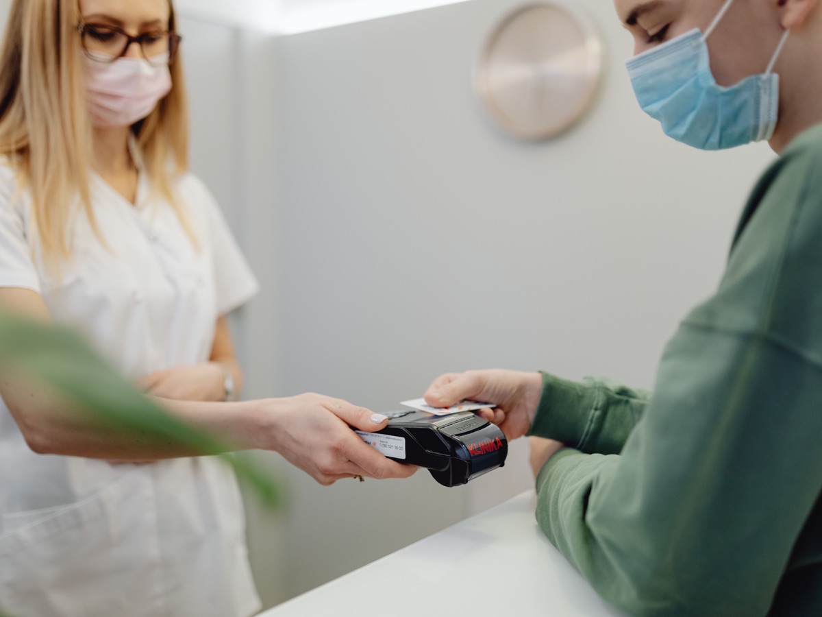 Patient making a card payment for healthcare