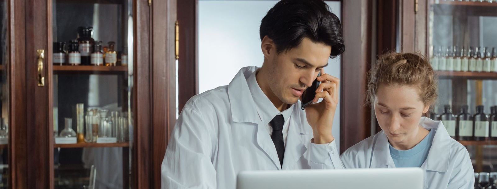 Pharmacists working at a pharmacy computer